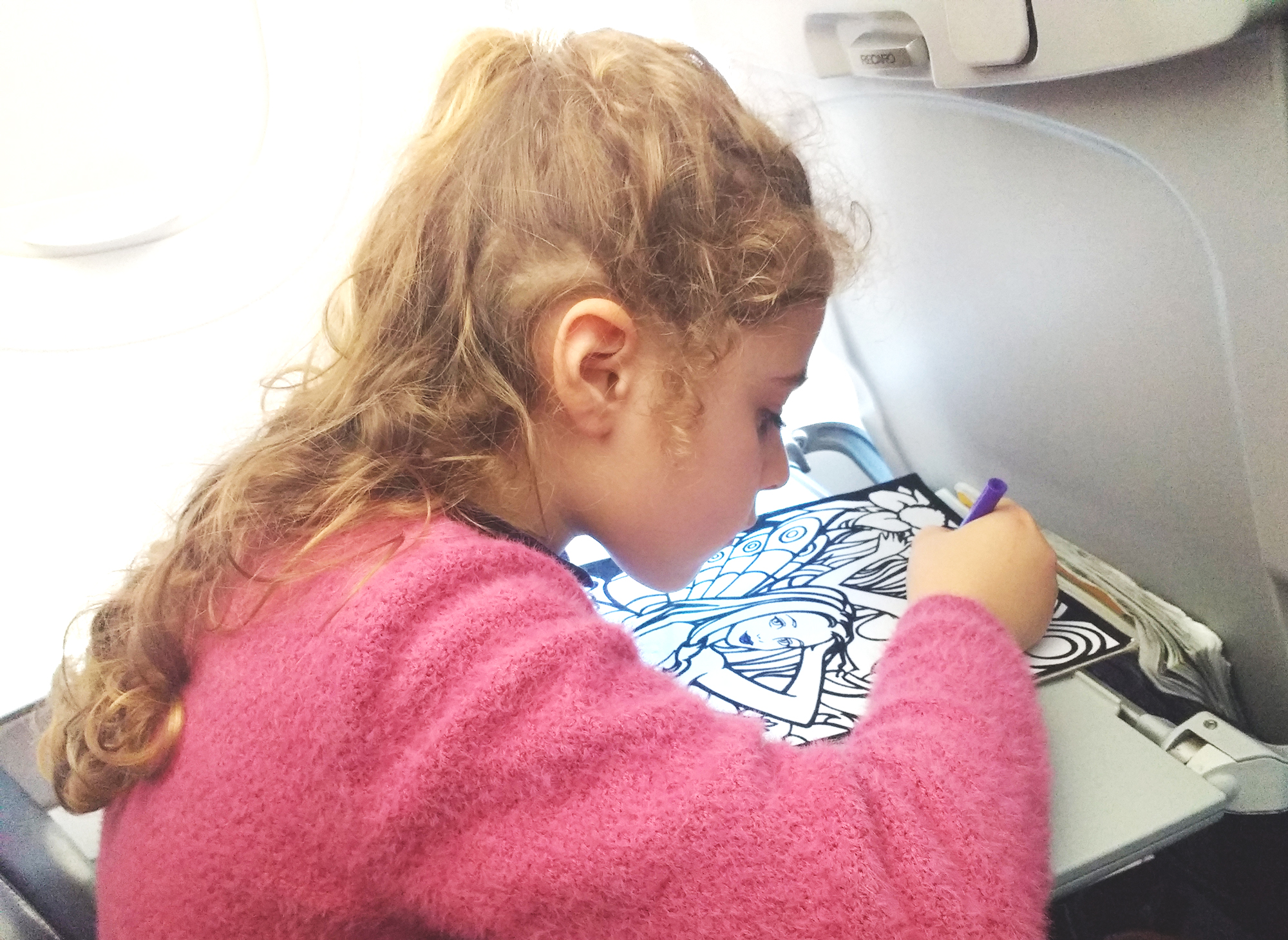 Viaggiare con i bambini- 5 consigli da tenere bene a mente_bambina in aereo